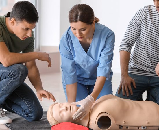People learning to perform CPR at first aid training course